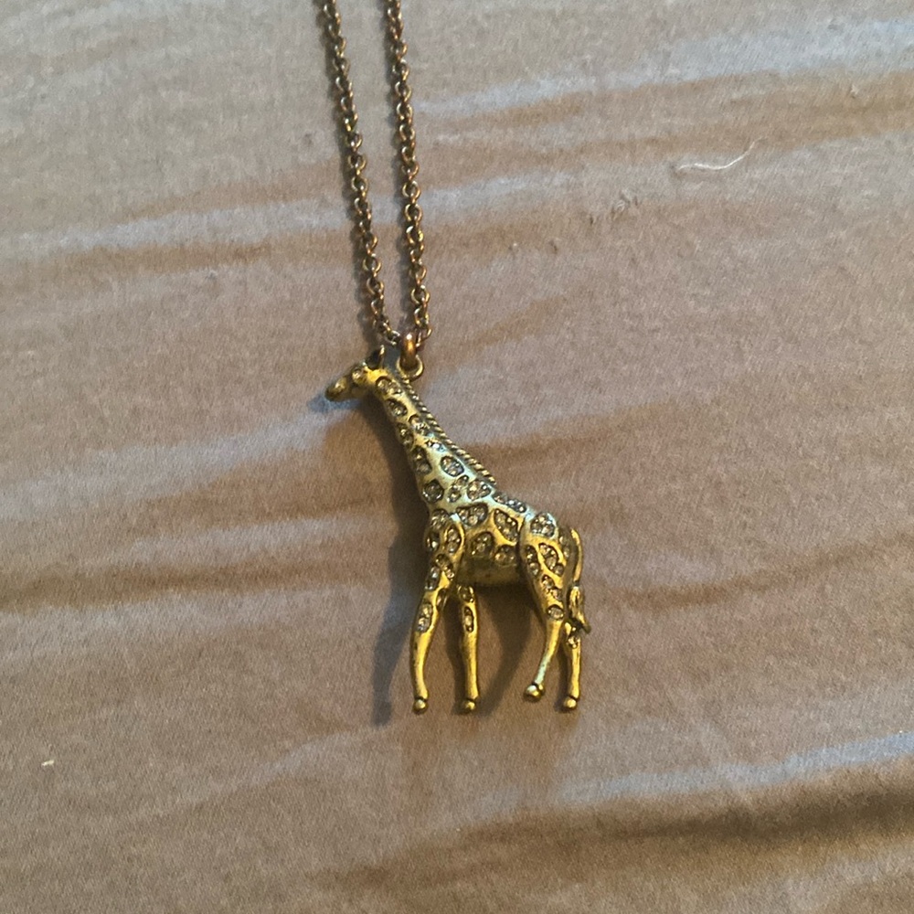 Fossil giraffe pendant necklace on gold chain. Good condition